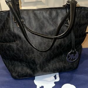 Black leather MK Tote bag.  Multiple compartments for your belongings.